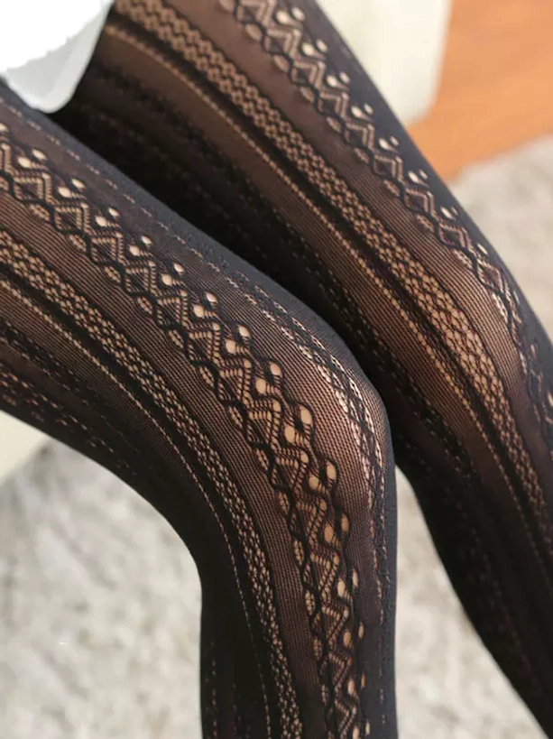 Black embroidered lace tights with dark brown diamond hollow stripe design sheer fabric close-up showing intricate lace work and gothic lolita aesthetic