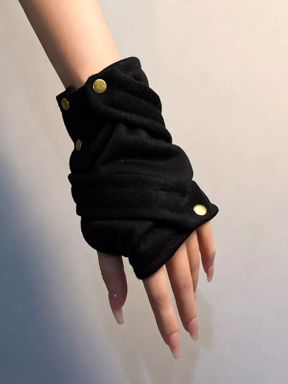 Front close-up of black fingerless wrist gloves featuring crisscross wrapped shape and golden snap buttons, detailed forearm and hand display showing intricate rivet embellishments and fabric layering
