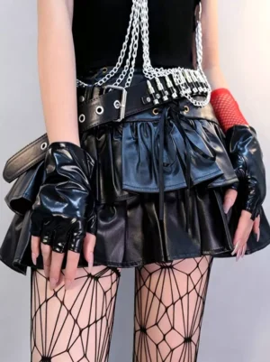 Black fingerless punk gloves worn by model in gothic lolita streetwear with red fishnet sleeves and spiderweb tights, partial front view
