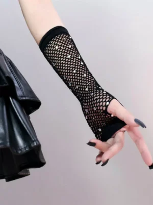 Close-up side view of black mesh fishnet fingerless gloves on arm and hand with black nail polish against light gray background, highlighting woven texture