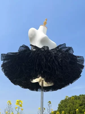 Black gauze lolita petticoat rear angle displaying dense layered ruffles and exceptional volume with natural outdoor lighting