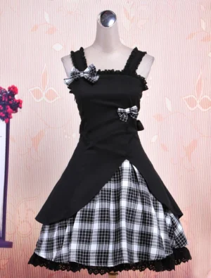 Black gingham Gothic Lolita jumper skirt front view showcasing bow appliqués and ruffled trim details on headless dress mannequin