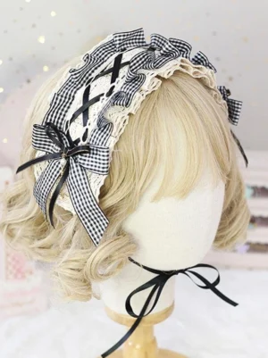 Black gingham lolita headband with cream ruffled lace and cross straps worn on mannequin head with fairy lights backdrop