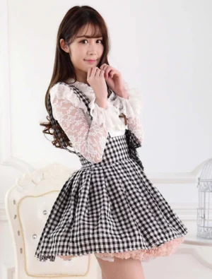 Side three-quarter angle of black gingham lolita suspender skirt showing pleated flared silhouette with lace blouse and gingham straps