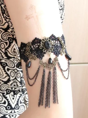 Gothic black hollow lace choker accessory with shorter chain tassels and bronze hardware shown from rear angle