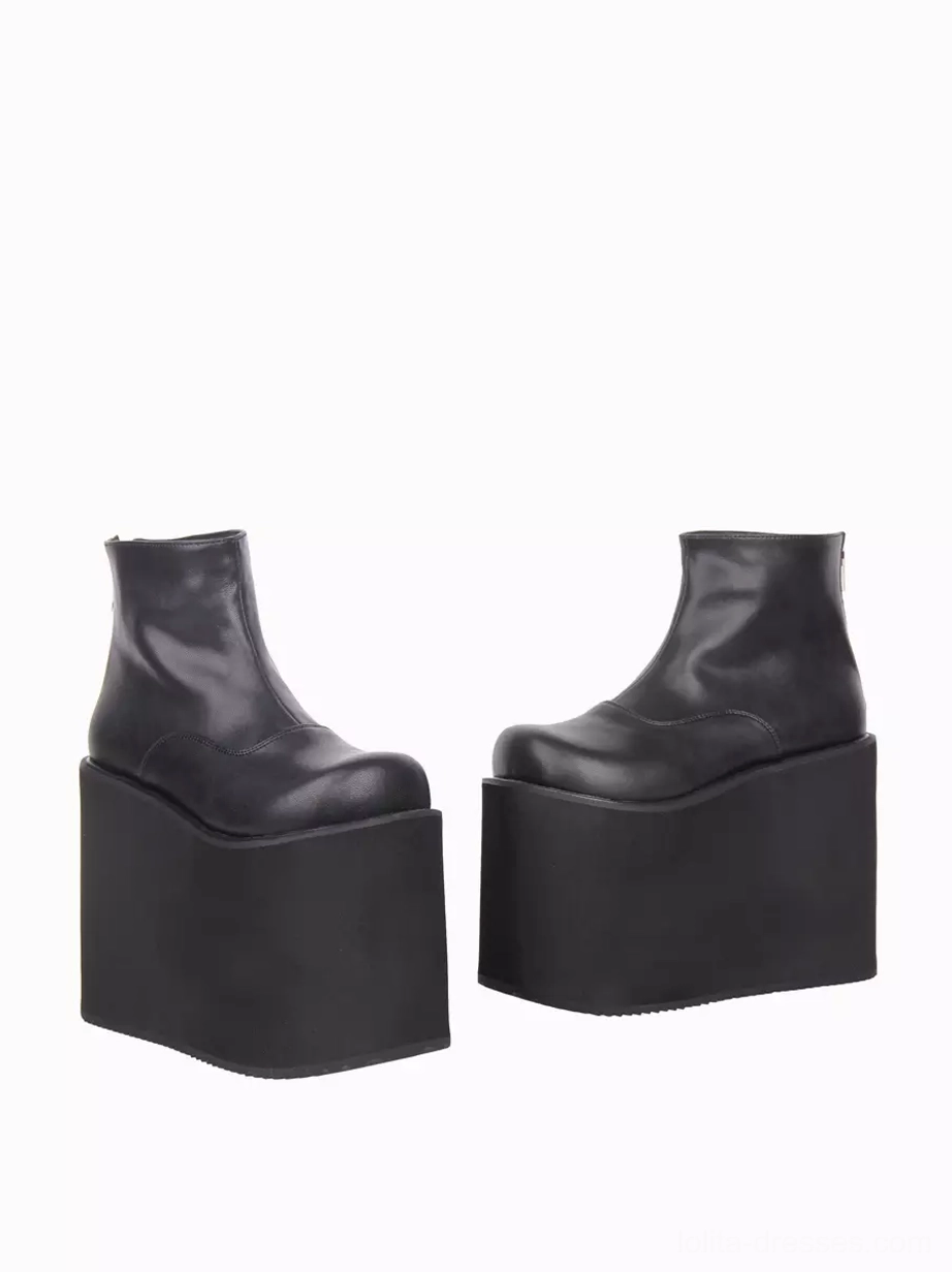 Black gothic lolita wedge heel ankle boots side profile view showing minimalist silhouette rear zipper closure and thick rubber wedge sole