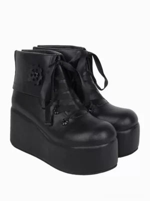 Black gothic lolita platform ankle boots with mechanical gear details and brown ribbon laces - front oblique view highlighting round toe and architectural design
