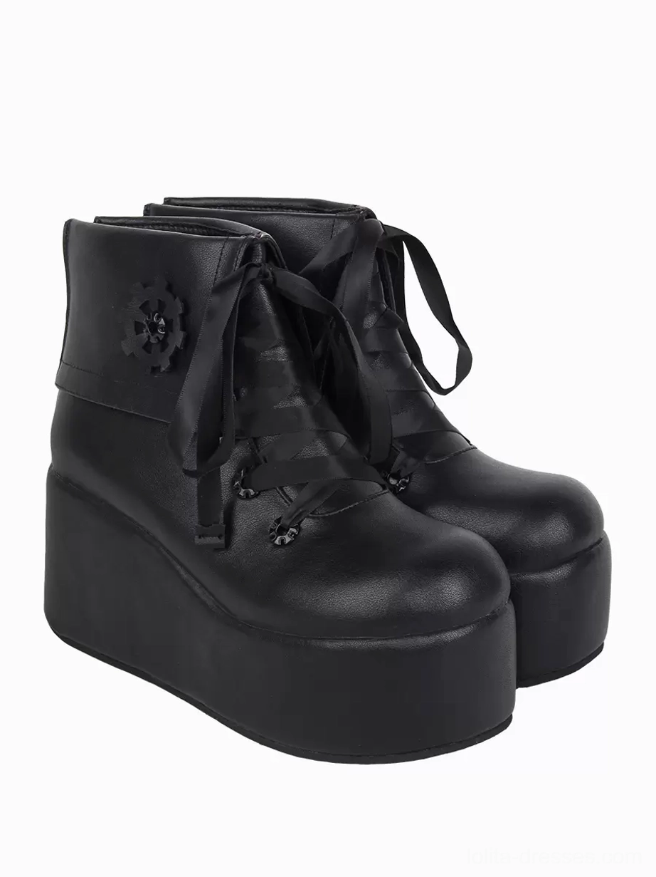 Black gothic lolita platform ankle boots with mechanical gear details and brown ribbon laces - front oblique view highlighting round toe and architectural design