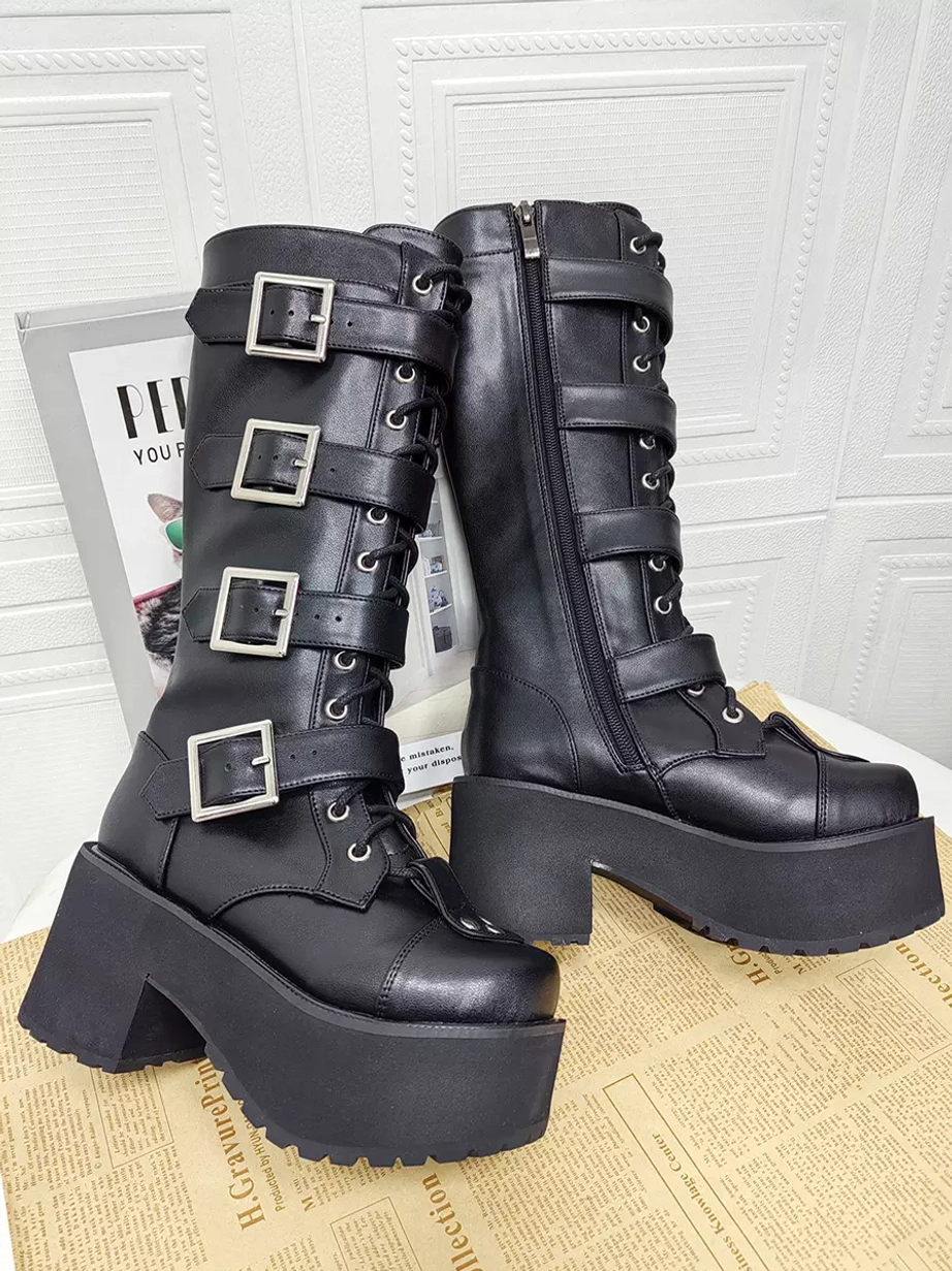 Pair of black Gothic Lolita platform boots side view showing inner zipper closure multiple buckle straps thick block heel and polished leather finish