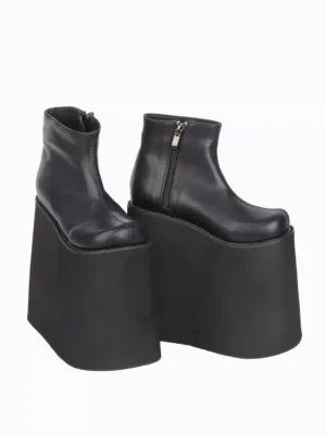Black Gothic Lolita boots side three-quarter perspective displaying polished PU leather surface, functional metal side zipper closure, and substantial wedge platform construction