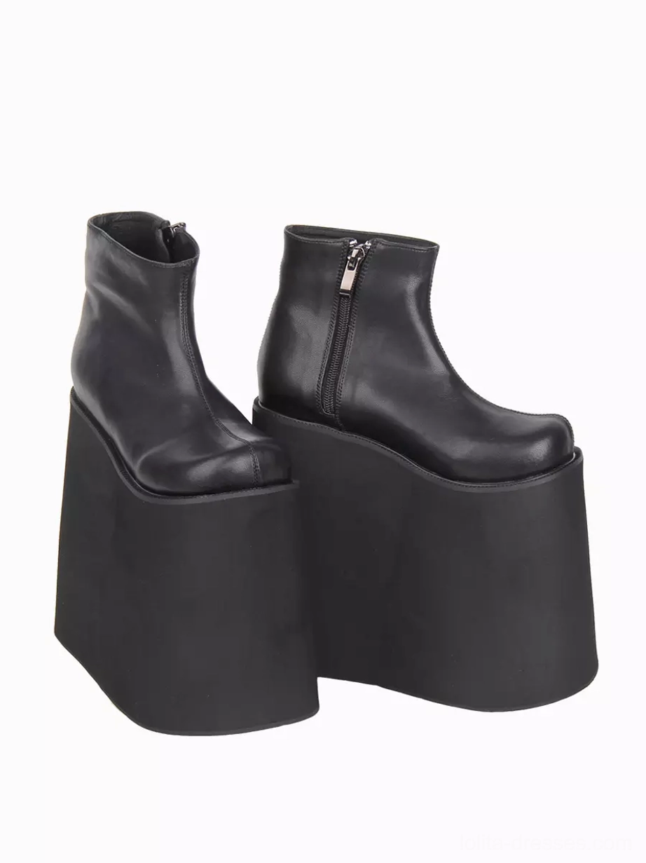 Black Gothic Lolita boots side three-quarter perspective displaying polished PU leather surface, functional metal side zipper closure, and substantial wedge platform construction