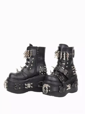 Side oblique view of black gothic platform wedge boots featuring side zipper and metal skull decorations