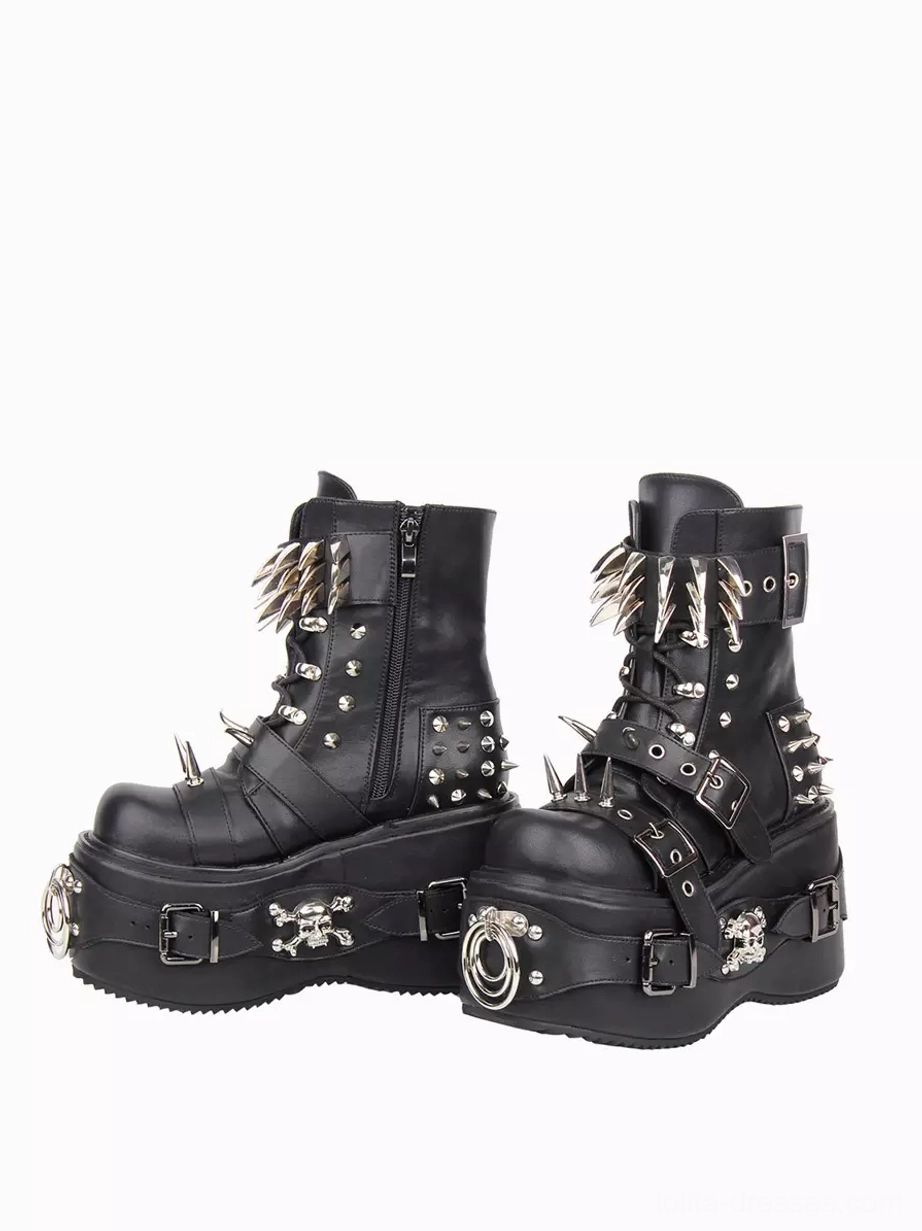 Side oblique view of black gothic platform wedge boots featuring side zipper and metal skull decorations