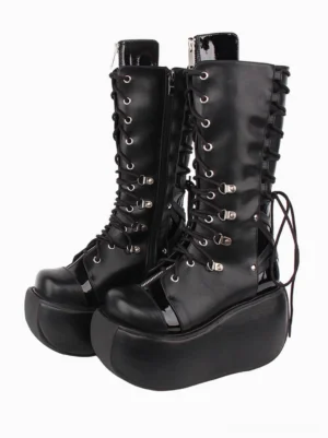 Black gothic lolita boots front three-quarter view showing inner side zipper, patent leather heel tab, silver metal eyelets and grommets detail