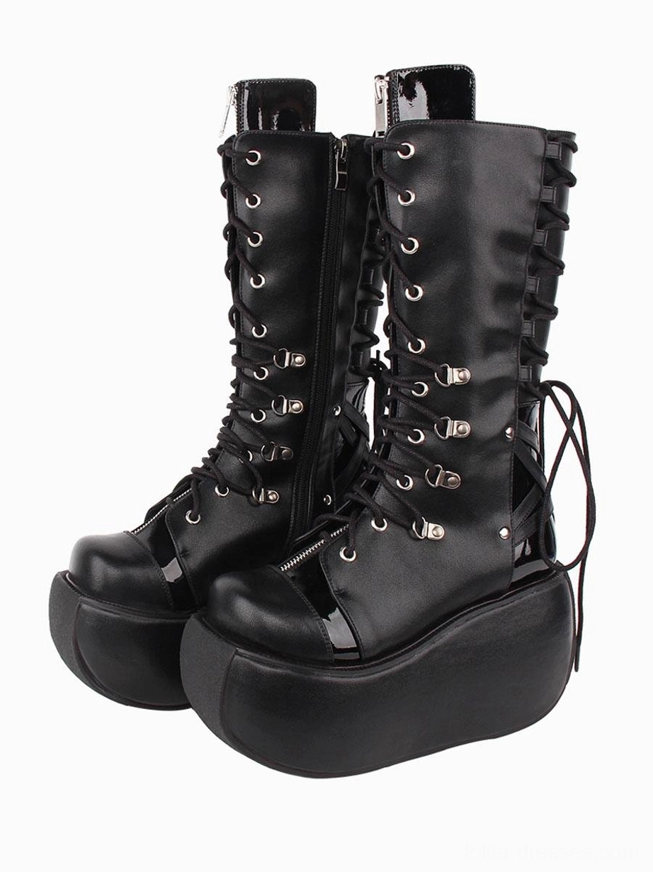 Black gothic lolita boots front three-quarter view showing inner side zipper, patent leather heel tab, silver metal eyelets and grommets detail