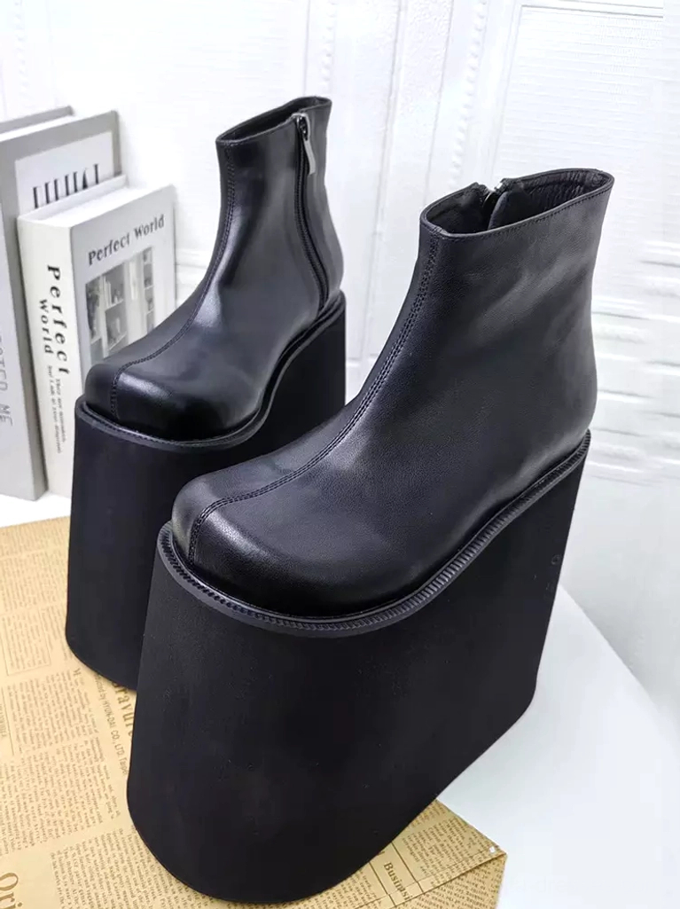 Black Gothic Lolita platform boots styled with books and vintage props showing 18cm marked wedge sole, functional side zippers, and fashion coordination context