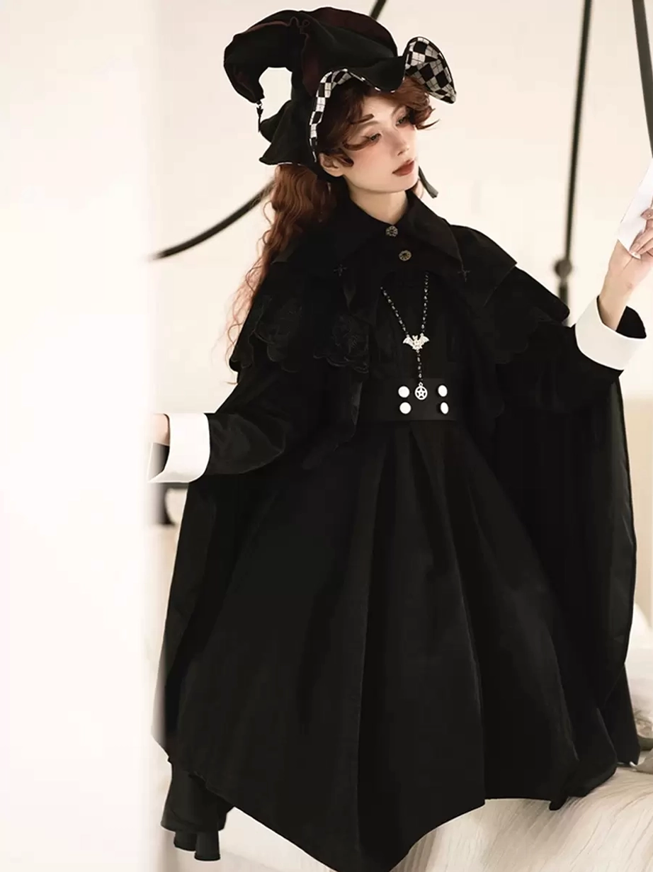 Gothic Lolita black cape poncho side view displaying flowing A-line silhouette and layered capelet details on model wearing checkered witch hat