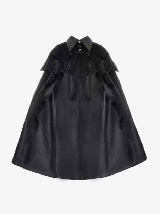 Flat lay product shot of black Gothic Lolita sleeveless cloak on white background showing embroidered layered capelet, pointed collar, smooth matte black polyester fabric texture detail