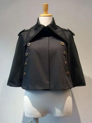 Black Gothic Lolita cropped cape front view displayed on dress mannequin featuring double-breasted bronze metallic buttons, wide notched lapel collar, and tailored cropped silhouette perfect for elegant lolita coordinates