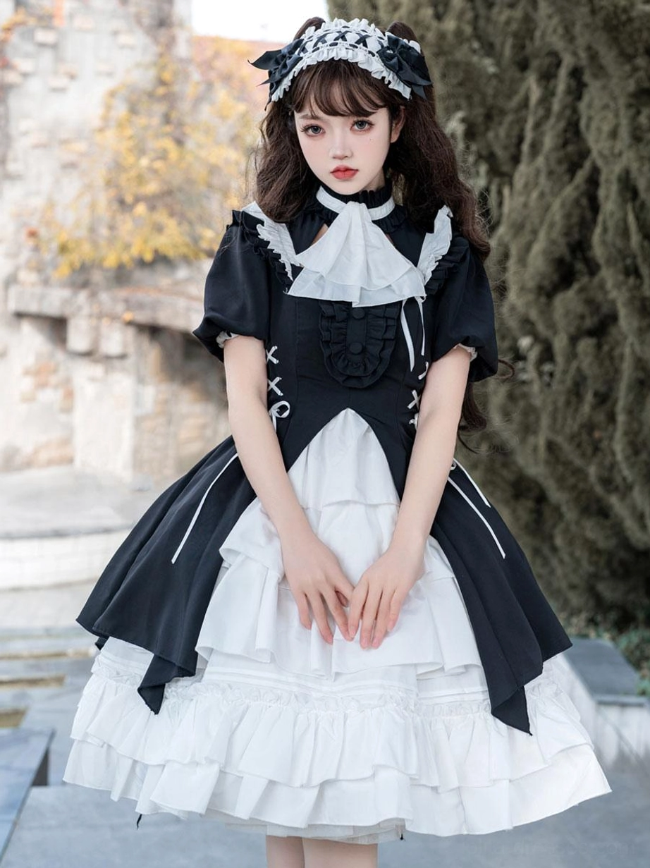 Black gothic lolita dress back view showing short puff sleeves, ruffled neck panel, lace-up bodice, and layered white underskirt