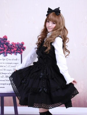 black gothic lolita dress sleeveless cotton with white blouse three-quarter view flower studio backdrop