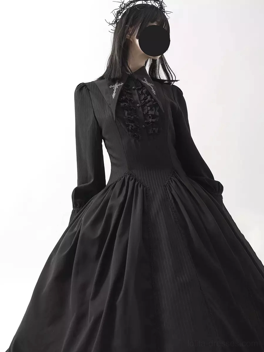 Black Gothic Lolita midi dress close-up front angle, showing detailed ruffled collar, structured waist, long sleeves, full A-line skirt, and model wearing black floral hair crown
