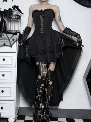 Gothic lolita high-low train skirt back view with skeleton fishnet stockings and platform boots, three-quarter rear angle