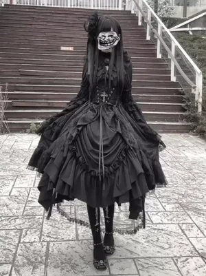 Black gothic lolita dress with lace-up corset waist front view, featuring tiered ruffled skirt and long sleeves on female model