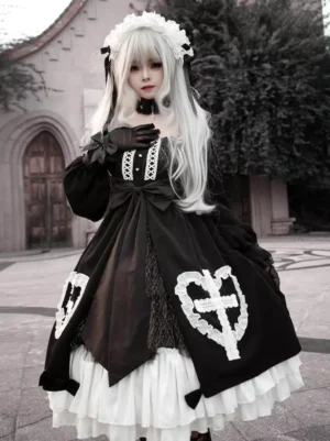 Black Gothic Lolita dress with lace ruffles, long sleeves, and heart cross embroidery worn by silver-haired cosplayer in outdoor church setting