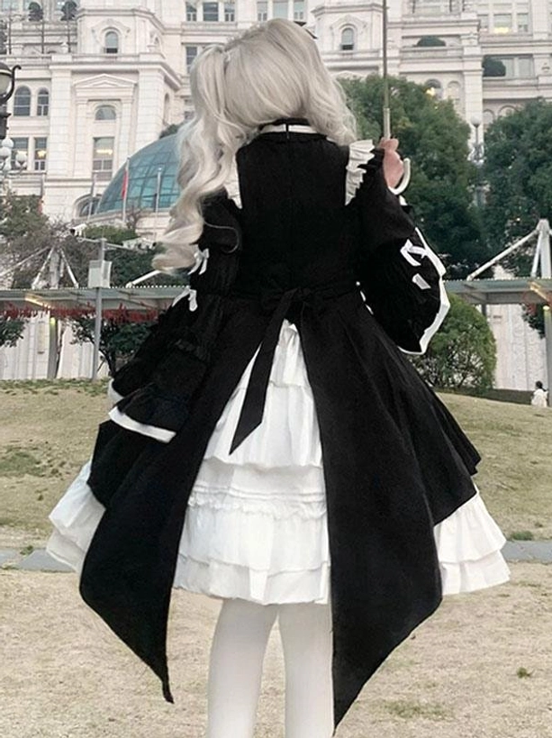 Back view of gothic lolita dress on mannequin showing asymmetric high-low hem, sleeve bows, back lace-up detail, and layered white underskirt structure