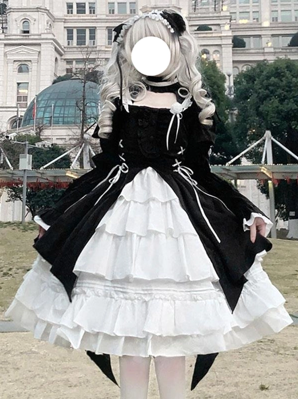 Full-length front view of gothic lolita dress on mannequin displaying off-shoulder neckline, lace-up bodice, tiered ruffled skirt, and black-white color coordination