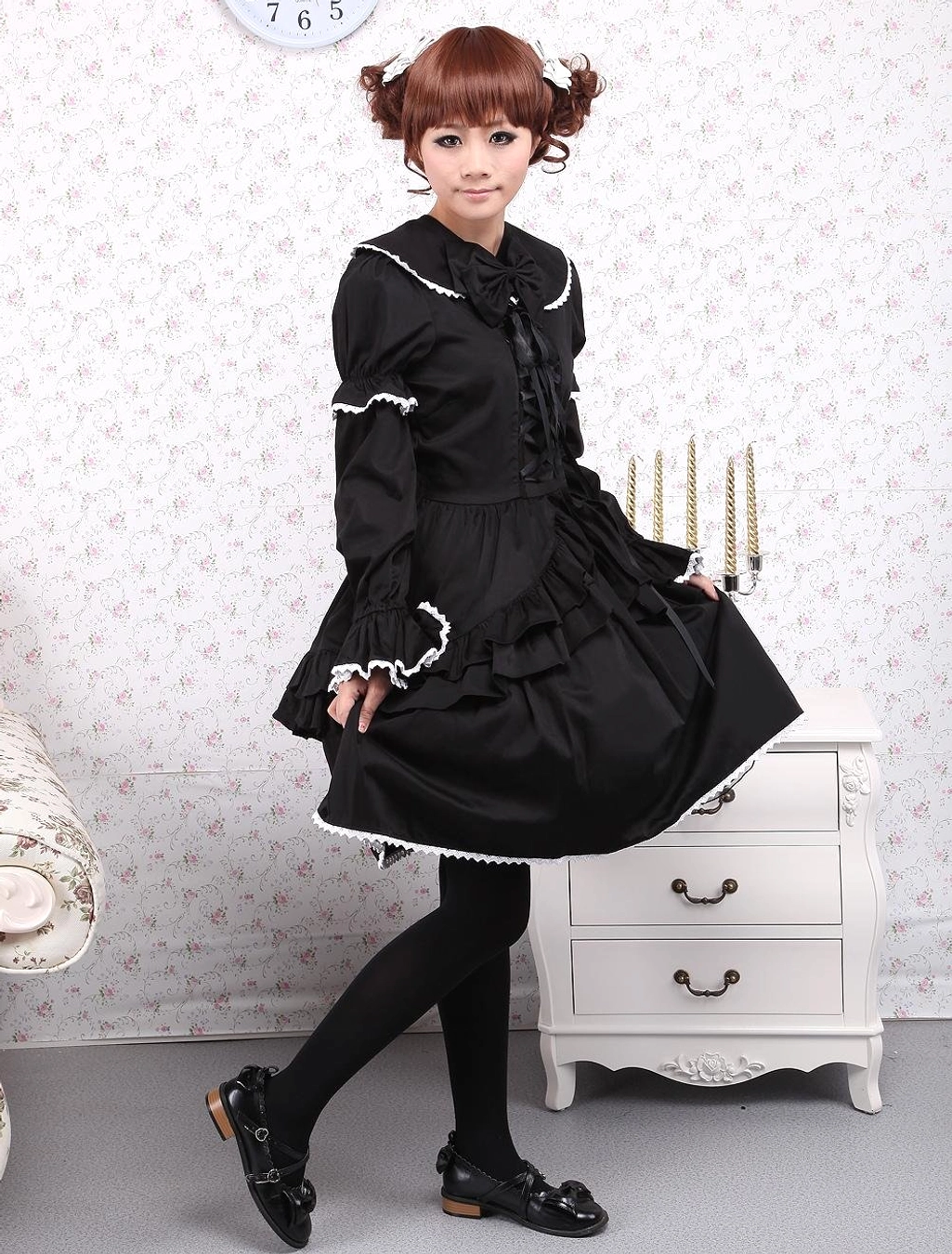 Model wearing black cotton Gothic Lolita OP dress styled with black opaque stockings and leather Mary Jane shoes for complete coordinate