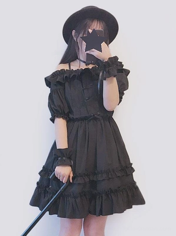 Black Gothic Lolita dress off-shoulder puff sleeves tiered ruffled hem side front view model wearing black fedora