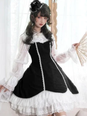Black gothic lolita dress front full-body view with ruffled lace skirt, sheer puff sleeves, and white doll collar on model with vintage hairstyle holding folding fan
