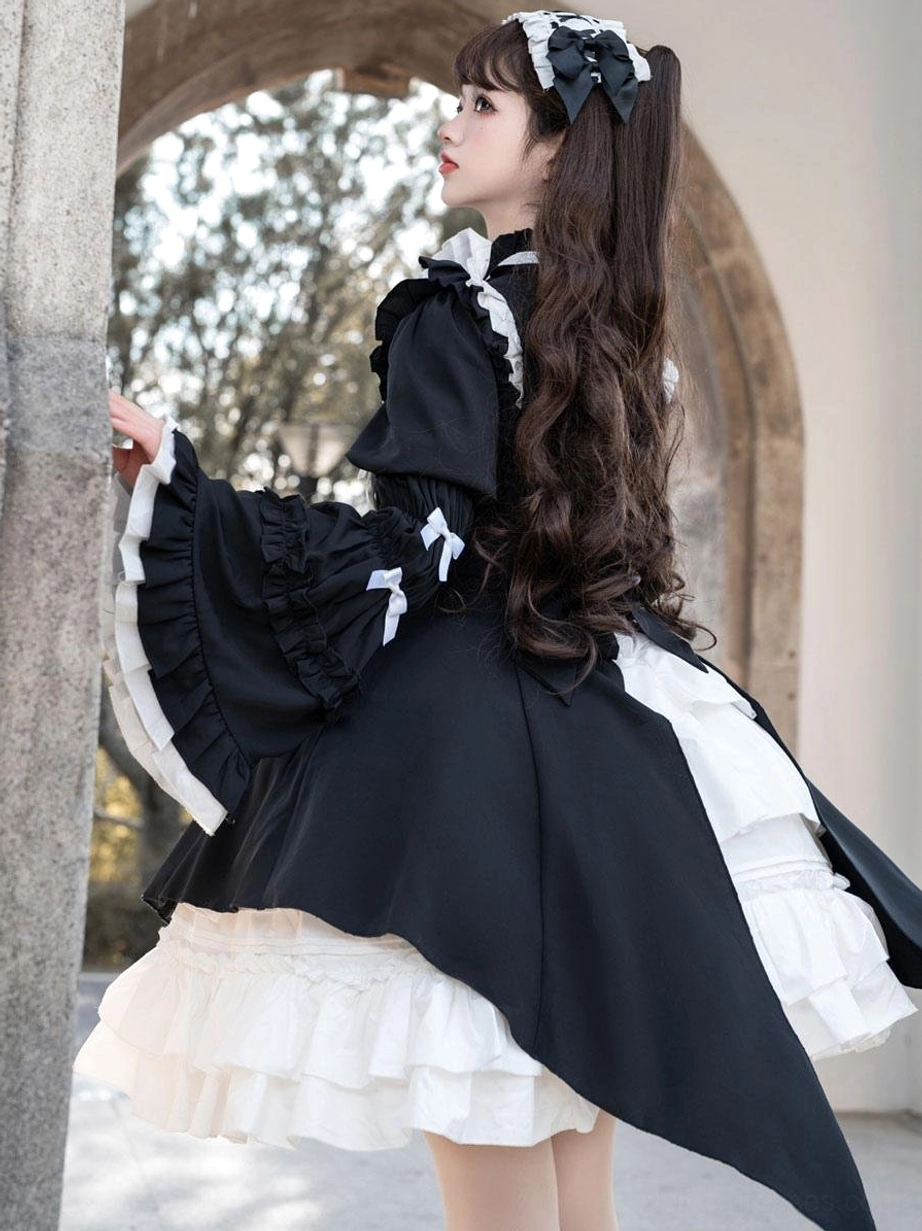 Side back view of gothic lolita dress showing trumpet sleeves with bows, high-low black overskirt, and layered white underskirt volume