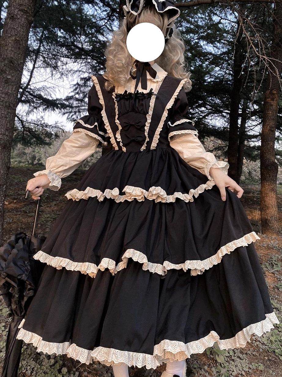 Black gothic lolita dress front view square lace-trimmed neckline layered ruffled skirt held with black umbrella prop