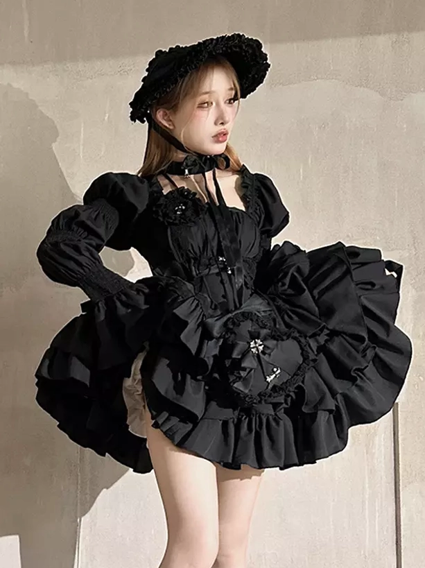 Black Gothic Lolita dress styled with accessories, showcasing complete coordinate versatility, cross brooch placement, ruffle embellishment details, and professional fashion photography