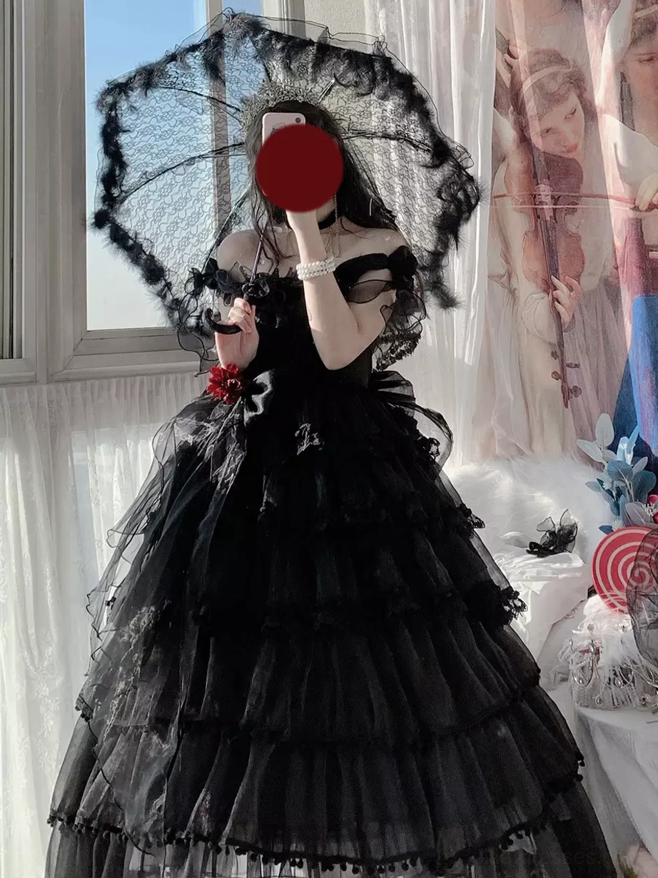 Black gothic lolita dress featuring tiered tulle skirt with off-shoulder design, ruffled hem details, and lace parasol accessory