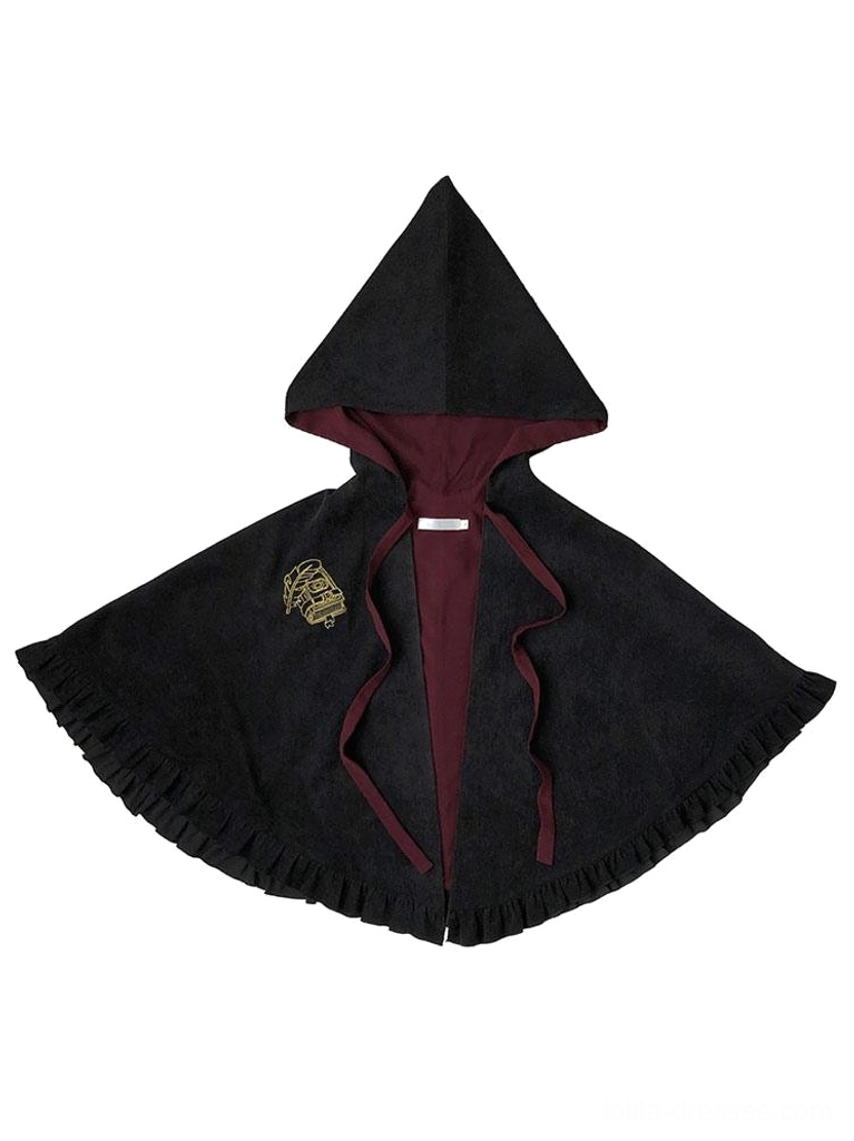 Flat lay display of black hooded lolita cape poncho exterior with wine red lining embroidered badge drawstring tie ruffled hem
