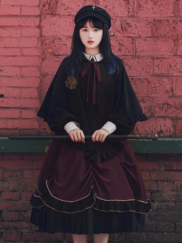 Black gothic lolita embroidered cape poncho with wine red lining worn over matching dress coordinate front full body view
