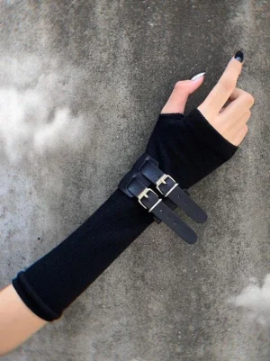 Black gothic lolita fingerless arm warmers close-up view with dual leather buckles and silver hardware on female hand with black nail polish