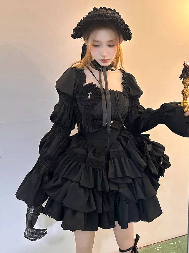 Model wearing full black Gothic Lolita set featuring ruffle bucket hat, neck choker, one black glove accent, multi-layer ruffle skirt, cross detailing, puff sleeves, refined goth aesthetic