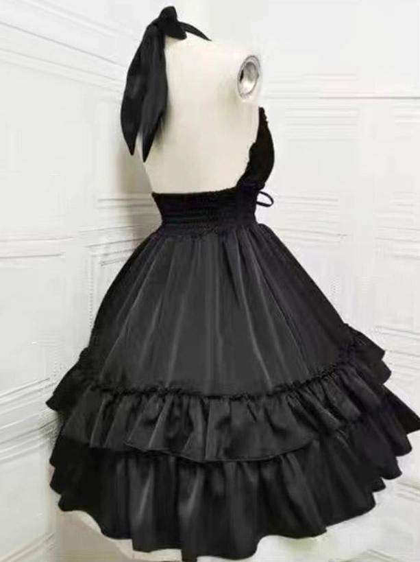 Black gothic lolita halter dress back view showing halter bow, lace-up detail and layered ruffled skirt structure