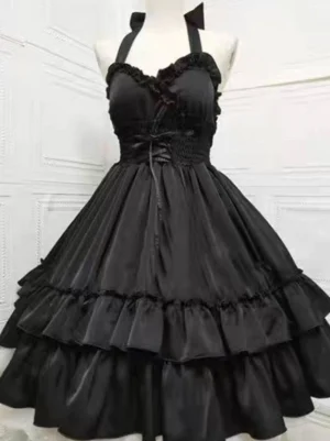 Black gothic lolita halter jumper dress with lace-up front and two-tier ruffled skirt, front view on dress form