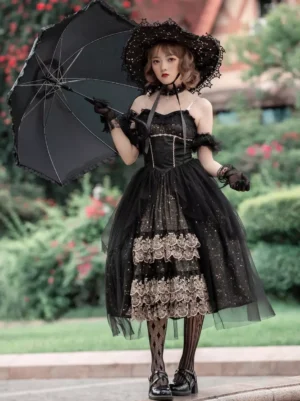 Front full-body view of Black Gothic Lolita JSK dress featuring glitter tulle skirt, corset bodice with lace details, model holding parasol in floral courtyard