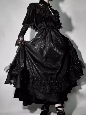 Black gothic lolita JSK dress front three-quarter view showing pearl neck trim gathered waist shiny jacquard layered skirt