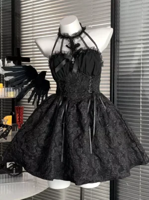 Black gothic lolita JSK dress with halter neck and lace-up corset front, displayed on mannequin from front left three-quarter view showing beaded halter straps, jacquard floral fabric details, and chest satin bow against dark gothic-themed background