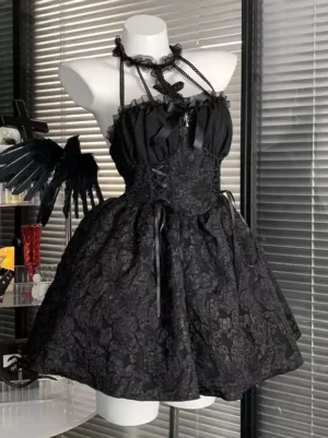 Gothic lolita sleeveless dress featuring beaded halter straps, decorative cross pendant ornament, and satin chest bow, photographed from right front three-quarter angle on mannequin with gothic backdrop