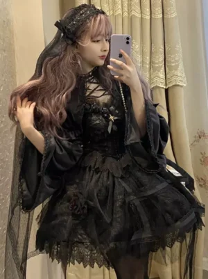 Black Gothic Lolita Jumper Skirt Side Profile Mirror Selfie Showing Lace-Up Neckline and Sheer Cape Overlay with Veil Accessory