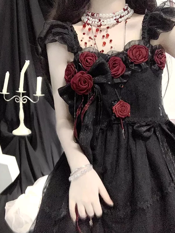 Black Gothic Lolita JSK upper bodice close-up with ruffled shoulder straps red rose decorations and pearl jewelry accessories